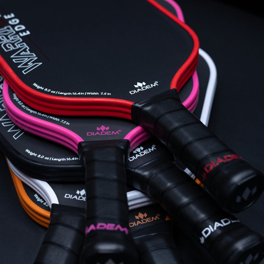 Set of Diadem pickleball paddles with colorful strings on a black background